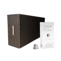 Carraro 1923 coffee capsule packaging showing a large matte black outer box, a white inner package labeled 'Aluminium', and a single silver capsule on a plain white background.